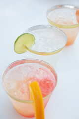 A view of some cocktails in plastic cups, seen at a local catered event.