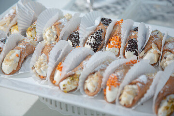 A view of several cannolis on a plate.