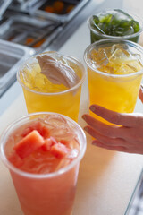A view of several cups of sugarcane drinks.