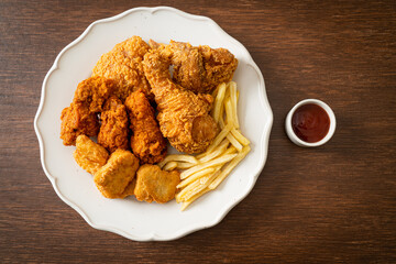 fried chicken with french fries and nuggets on plate