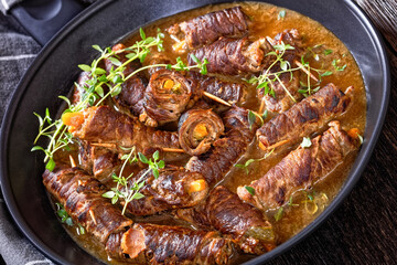 german beef rouladen in thick gravy on pan
