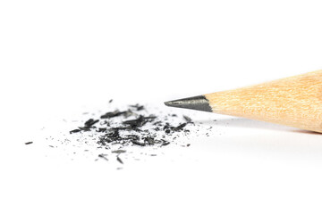 Sharpened pencil and graphite shavings on white