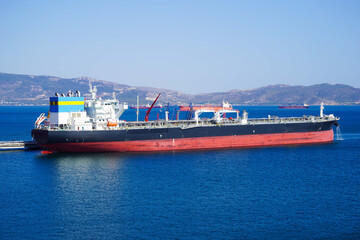 Fototapeta premium Sea transportation of Liquefied Petroleum Gas. LPG tanker is heading to LPG terminal for gas loading. international order concept.