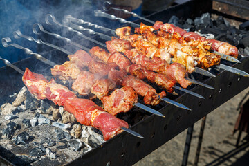 The meat is cooked on the grill. The process of cooking barbecue on coals.