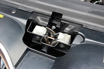 Modern car hood lock. Close up Engine bonnet lock. Modern vehicle hood opening lock.