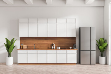 Stylish kitchen interior with fridge and cooking area with kitchenware