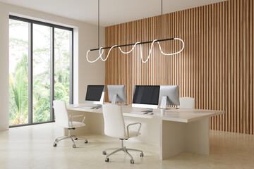 Corner view on bright office interior with desks with computers