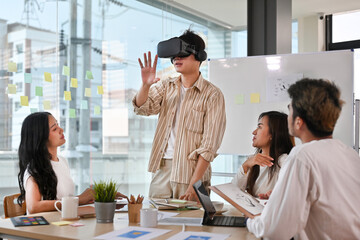 Diverse development team testing virtual reality headset, brainstorming on augmented reality...