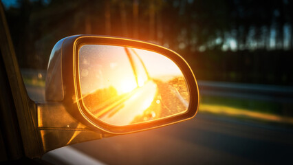 Car sunset road mirror. Summer sun, highway car road reflection in mirror. Vacation trip concept.