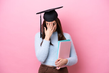 Young student Brazilian woman wearing graduated hat isolated on pink background with tired and sick expression
