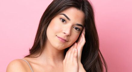Young Brazilian woman isolated on pink background . Portrait