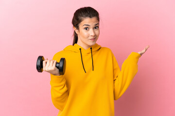 Young sport girl making weightlifting over isolated pink background having doubts while raising hands