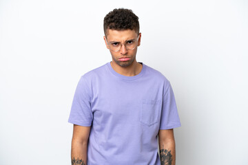 Young caucasian Brazilian man isolated on white background with sad expression