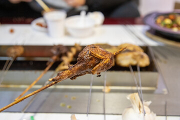 Chinese night roadside barbecue - grilled quail meat