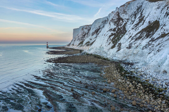 Epic vibrant Summer dawn landscape image of Beachy Head Lighthouse in South Downs National Park in England