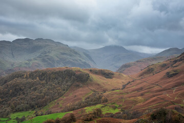 Beautiful vibrant Autumn landscape image towards Borrowdale Valley from Castle Crag in Lake District