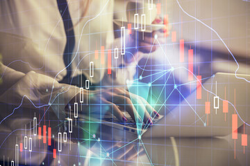 Double exposure of businesswoman hands typing on computer and financial graph hologram drawing. Stock market analysis concept.
