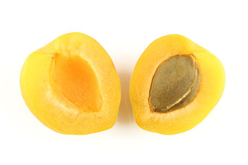 Two halves of apricot fruit with core seed isolated on white background