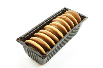 Jaffa biscuits in plastic package box isolated on white background