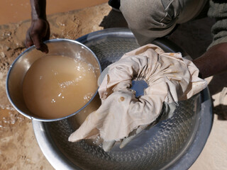 Artisanal miner using mercury to attract gold from ore mixed with water. Mercury is a toxic product...