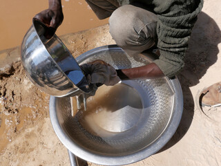 Artisanal miner using mercury to attract gold from ore mixed with water. Mercury is a toxic product...