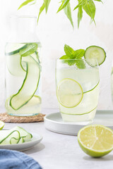 Refreshing infused water with cucumber, mint and lime. Summer drink cocktail lemonade. Healthy drink and detox concept