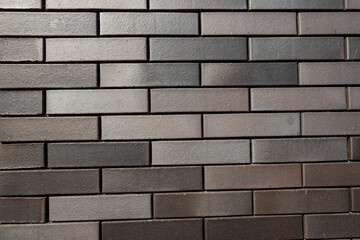 A black brick pattern shot from an exterior wall on a house in the Netherlands providing a rugged background or texture