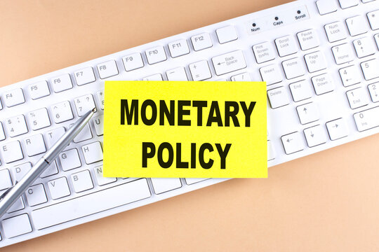 MONETARY POLICY text on a sticky on keyboard, business concept