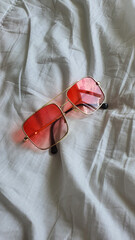 red sunglasses on a white background.red glasses on a white background.glasses close-up.red glasses close-up.sunglasses
