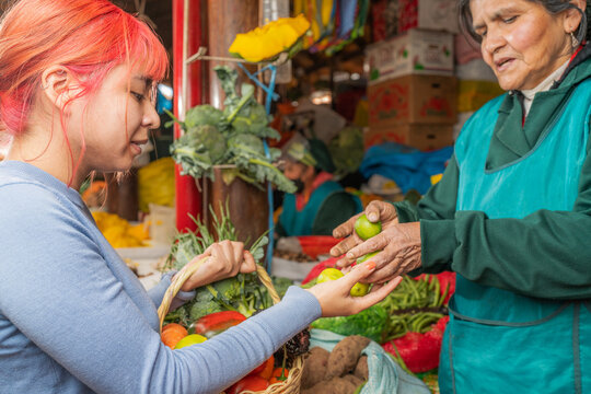 Peruvian woman selling limes on fair