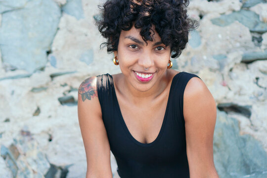 Crop lonely black woman with tattoo and piercing