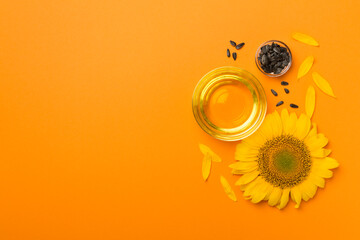 Sunflower oil, seeds and flower on color background