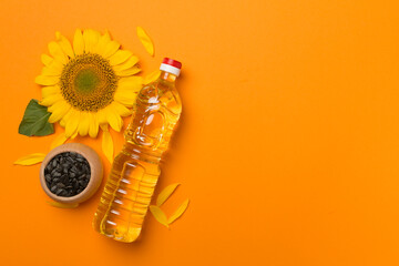 Sunflower oil, seeds and flower on color background