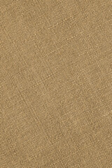 Light brown woven surface closeup. Linen textile texture. Fabric sewing elegant background. Textured braided home backdrop. Len vertical wallpaper. Macro