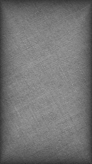 Gray woven surface close-up. Linen textile grey texture. Fabric net black and white background. Textured braided len backdrop. Mobile phone wallpaper with vignetting. Macro
