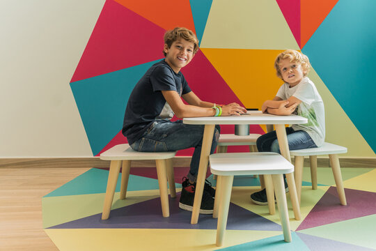 Kids sitting at table in clinic playroom