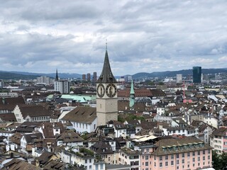 Fototapeta na wymiar Zurich Panoramic view from the top of Grossmunster, Switzerland, summer 2022. Most beautiful Swiss cityscape photos and top Switzerland tourist attractions and places