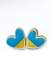 Plate with Two Heart shape ukrainian colours blue and yellow national flag gingerbread cookies on table. Flat lay, copy space