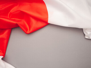 Top view of the Japan flag on a gray background with space for text