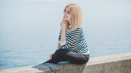 Girl in striped sweeter, fashionable details on a model, classical trend in wardrobe