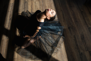 Ballerina laying down dance studio floor