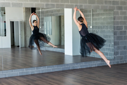 Young ballerina jumping at dance studio