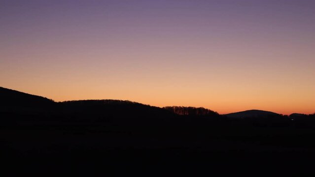 sunrise timelapse with mountains and red sky