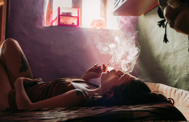 Female having relaxation while smoking weed