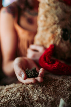 Anonymous lady showing weed on palm