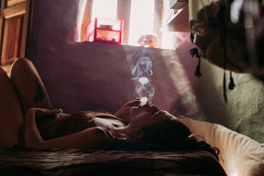 Female having relaxation while smoking weed