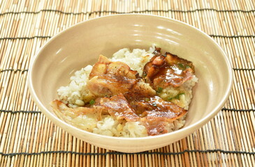 slice grilled salt pork with sauce topping Japanese rice on bowl