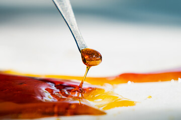 orange cannabis concentrate wax close up, high thc dab resin.