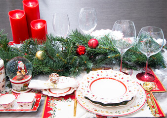 Beautiful table setting with Christmas decorations and red burning candles in living room