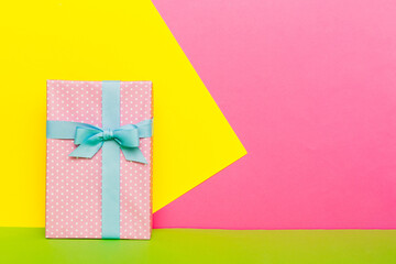 holiday handmade paper present tied blue ribbon bow top view with copy space. Flat lay holiday background. Birthday or christmas present. Christmas gift box concept with copy space